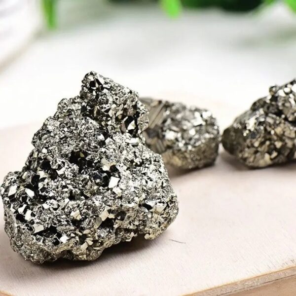 A close-up of shiny pyrite rocks showcasing their metallic appearance and cubic crystal structure, perfect for educational science displays or decorative purposes.