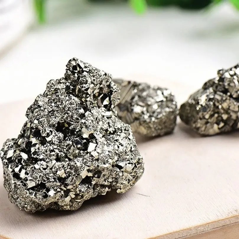 A close-up of shiny pyrite rocks showcasing their metallic appearance and cubic crystal structure, perfect for educational science displays or decorative purposes.