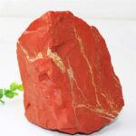 Bright red jasper mineral rock with natural gold-colored veining, ideal for science displays and educational purposes.