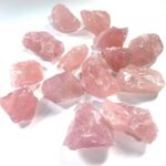 Pink Rose Quartz mineral stones for healing, meditation, and decorative purposes. Natural, rough-cut gemstones with a soft pink hue, perfect for educational displays or spiritual practices.