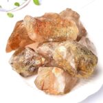 Natural golden quartz crystal rocks with shimmering golden inclusions, ideal for healing, meditation, and decorative purposes.
