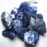Collection of blue sodalite mineral stones showcasing vibrant blue and white patterns, ideal for science decor, educational displays, and geological study.