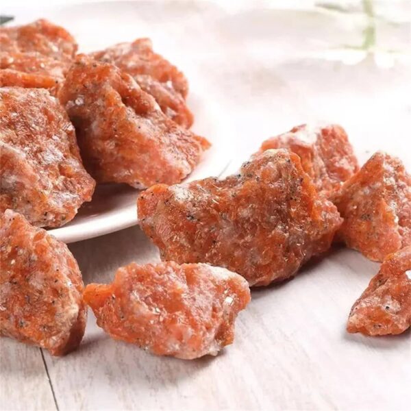 Close-up of salted caramel fudge pieces on a white surface, showcasing their rich texture and golden-brown color.