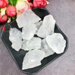 Raw crystal quartz stones displayed on a black dish, perfect for educational science projects and decorative purposes.