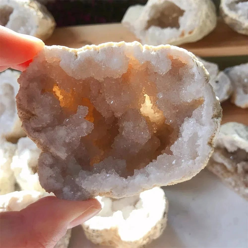 Close-up of a hollow geode with sparkling crystal formations inside, showcasing natural mineral beauty.