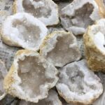 Close-up of geode crystals showing sparkling interior with rough outer rock surface, ideal for educational and decorative purposes.