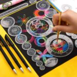 Brightly colored spirograph gears and pens for artistic design and learning activities.