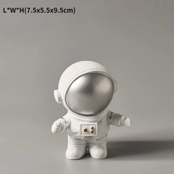 Adorable astronaut figurine with a silver helmet and white suit, perfect for science decor and educational toys. Compact size ideal for display or learning activities.