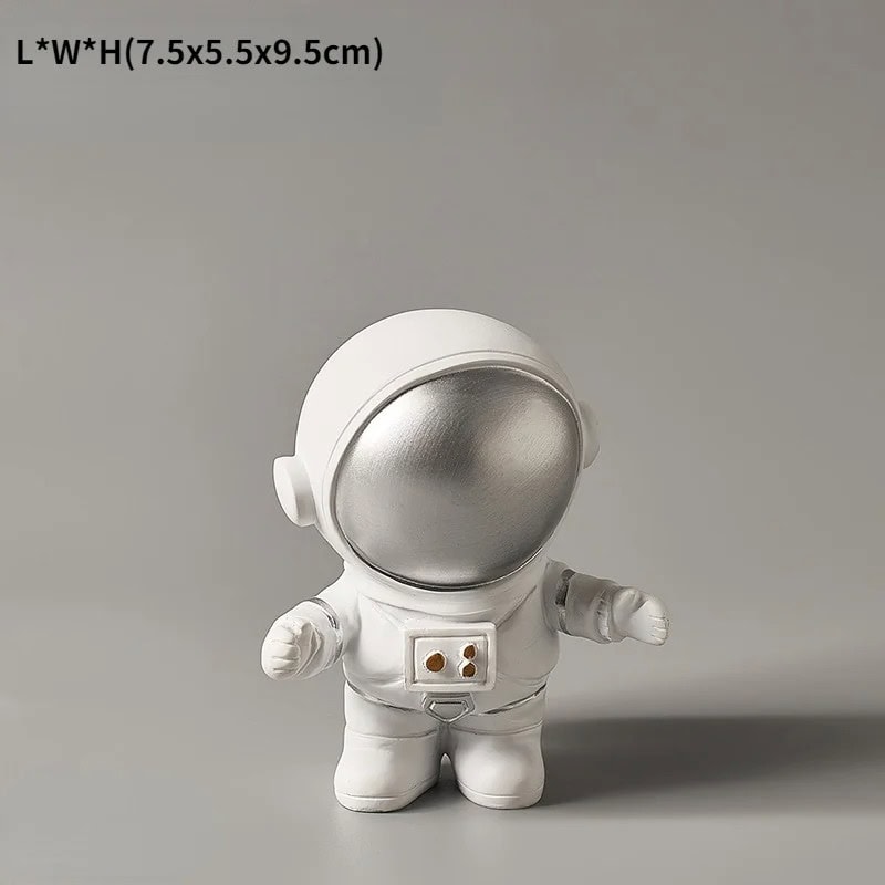 Space Explorer Figurine Adorable astronaut figurine with a silver helmet and white suit, perfect for science decor and educational toys. Compact size ideal for display or learning activities.