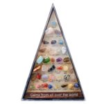 Collection of various colorful gemstones including amethyst, jade, quartz, and more, arranged in a pyramid shape for educational and decorative purposes.