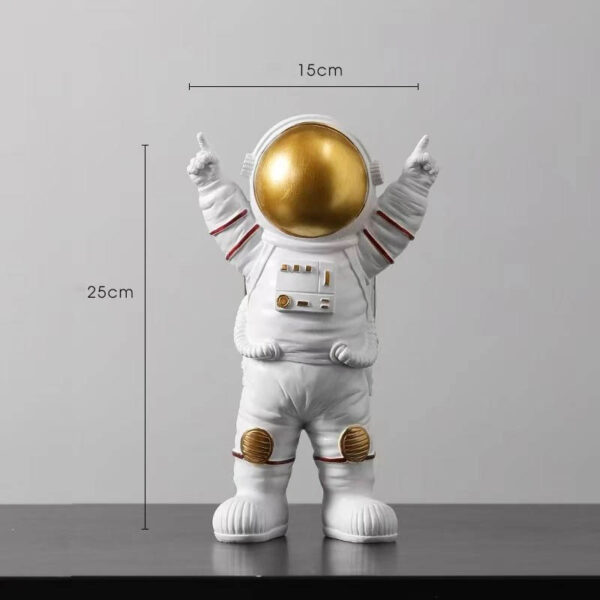 An astronaut figurine with a shiny gold helmet, white suit, and detailed patches, standing 25cm tall and 15cm wide, perfect for science decor and educational displays.