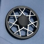 A close-up of a black and white geometric wheel with a central hub, designed for science experiments or educational demonstrations.