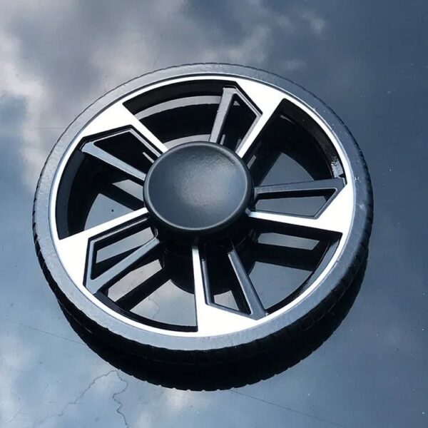 Small plastic wheel model with black and silver details, used for science experiments and educational displays.
