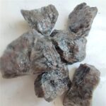 Close-up of six rough mineral rocks with varied textures and colors on a white background.