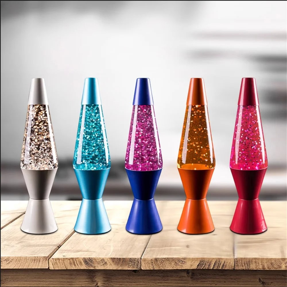 Lava Lamps Collection Colorful lava lamps with glittery liquid in various shades including silver, blue, pink, orange, and red, displayed on a wooden surface.