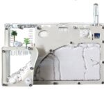 Miniature scientific experiment setup with transparent components and white textured surfaces.