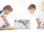 Two children, a girl and a boy, exploring a transparent computer science educational toy, engaging in hands-on learning about technology and circuitry in a bright, modern setting.