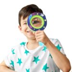 Child holding a colorful magnifying glass for science exploration.