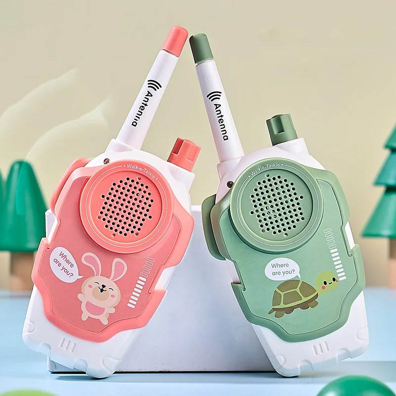 Pair of colorful children's walkie talkies in pink and green with animal designs, perfect for outdoor play and communication.
