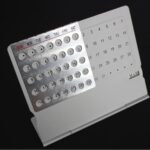 Compact magnetic perpetual calendar with rotating discs for days, dates, and months, ideal for organizing schedules and enhancing educational decor.
