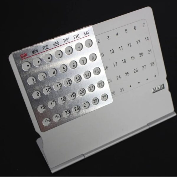 Compact magnetic perpetual calendar with rotating discs for days, dates, and months, ideal for organizing schedules and enhancing educational decor.