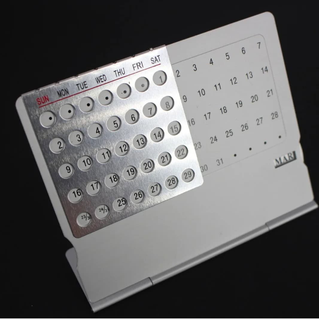 Mini Perpetual Calendar with Magnetic Discs Compact magnetic perpetual calendar with rotating discs for days, dates, and months, ideal for organizing schedules and enhancing educational decor.