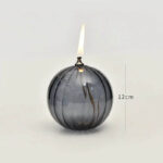 Decorative spherical candle with flame, measuring 12cm in height, ideal for science-themed decor and educational displays.