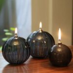 Beautiful glass candle holders with flickering flames, showcasing modern design and craftsmanship. Perfect for home decor, educational demonstrations, or science-themed decorations.