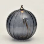 Elegant glass globe vase with swirling gray and clear patterns, ideal for home decor or educational displays.