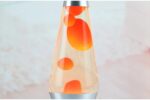 Colorful lava lamp with orange bubbles inside, creating a mesmerizing visual effect, perfect for science decor and educational settings.