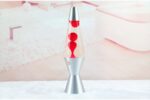 Modern lava lamp with red wax inside a clear glass tube, mounted on a silver base, creating a vibrant and dynamic decorative piece for science enthusiasts and home decor.