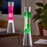 Modern lava lamps with pink and green liquid and bubbles, placed on a wooden table in a cozy living room setting.