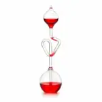 Glass chemistry apparatus with red liquid, demonstrating scientific experiments.