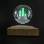 A magnetic levitation globe with glowing green LED bars floating inside a transparent sphere, mounted on a wooden base, demonstrating magnetic levitation technology.