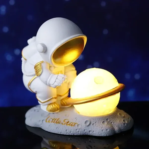 Adorable astronaut figurine holding a luminous planet with rings, perfect for space-themed decor or educational displays about the solar system.