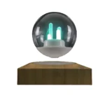 Illuminated plasma ball with glowing electric filaments inside a glass sphere on a wooden base, showcasing a captivating science decor piece.