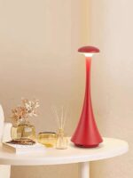 Stylish red table lamp with a sleek, elongated design and a rounded top, perfect for contemporary home decor.