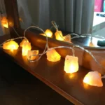 Salt rock string lights, warm glowing decorative lighting, ideal for home decor, parties, or educational displays, featuring natural mineral aesthetic and cozy ambiance.