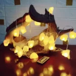 LED string lights wrapped around a piece of driftwood, creating a warm, cozy glow.