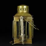 Antique brass lantern with a rope inside, showcasing vintage design and craftsmanship. Perfect for educational displays or as a decorative piece in science-themed settings.