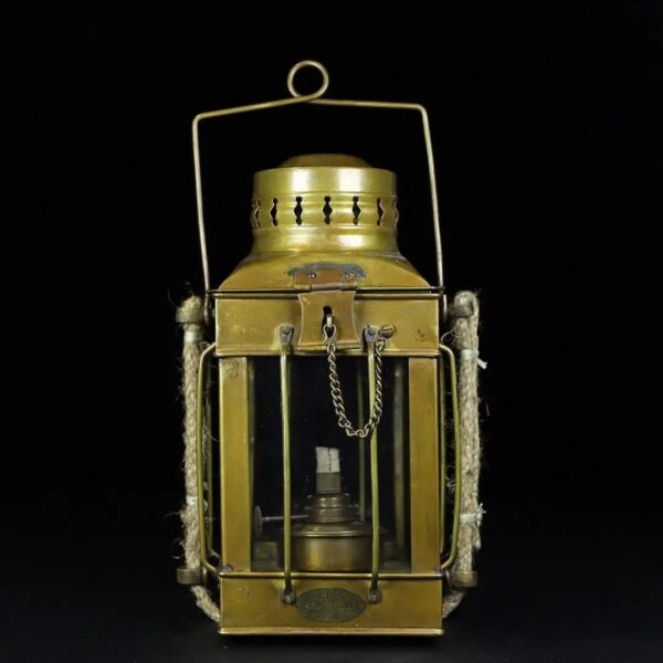 Vintage metal lantern with glass panels, chain handle, and decorative details.