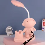 Adorable astronaut-themed night light featuring a soft pink color, a rocket-shaped lamp, and a playful design suitable for children's decor.