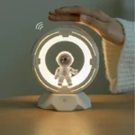 Cute astronaut toy with a holographic display and a hand hovering above it.