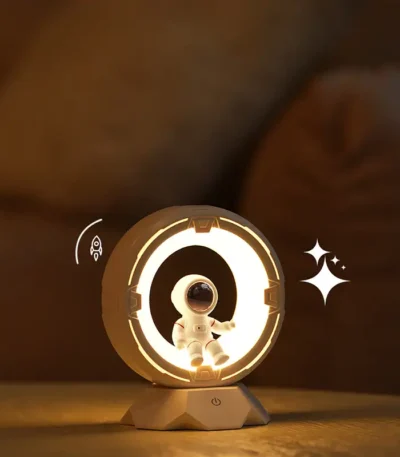 Astronaut night light with glowing ring and star accents, perfect for a space-themed room or educational decor.