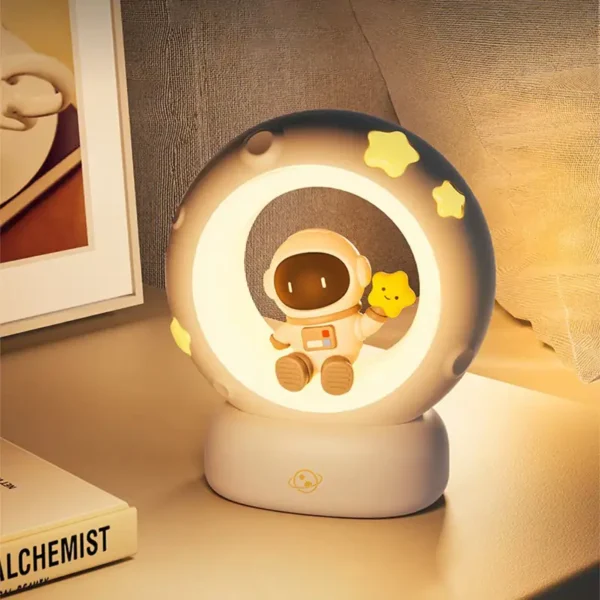 Adorable astronaut-themed night light featuring a cute astronaut holding a star, surrounded by glowing stars, perfect for children's bedrooms or nurseries.