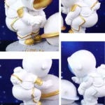 Astronaut figurine with a white suit and gold accents, holding a small planet or moon, designed as a decorative science-themed collectible.