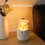 Natural crystal salt lamp with a glowing light, placed on a wooden surface next to a white vase with flowers, creating a cozy ambiance.