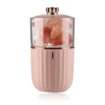 Compact pink Himalayan salt grinder with a transparent top showing pink salt crystals, ideal for culinary use and kitchen decor.