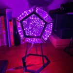 LED geometric art lamp with vibrant purple lighting for modern decor.