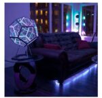 LED geometric lamp with colorful illuminated hexagonal panels, creating a vibrant and futuristic ambiance in a contemporary living space.